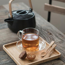 Load image into Gallery viewer, Tea cup with teapot and wooden tray on a wooden surface
